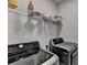 A practical laundry room featuring modern washer and dryer units and convenient overhead shelving for storage at 3415 Crop Corner Rd, Suwanee, GA 30024