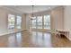 Bright open living room with hardwood floors, large windows and hanging chandelier at 3415 Crop Corner Rd, Suwanee, GA 30024