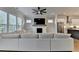 Open-concept living room features a cozy fireplace, large TV, and a modern ceiling fan at 3415 Crop Corner Rd, Suwanee, GA 30024