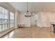 Bright open living room with hardwood floors, large windows and hanging chandelier at 3415 Crop Corner Rd, Suwanee, GA 30024
