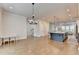 Spacious living room with an open floor plan, hardwood floors, and elegant light fixtures at 3415 Crop Corner Rd, Suwanee, GA 30024