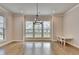 Bright open living room with hardwood floors, large windows and hanging chandelier at 3415 Crop Corner Rd, Suwanee, GA 30024
