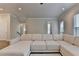 View of living room with sectional sofa, access to the staircase and an outdoor patio at 3415 Crop Corner Rd, Suwanee, GA 30024