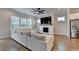 Bright living room with a fireplace, large sectional sofa, ceiling fan, and hardwood flooring at 3415 Crop Corner Rd, Suwanee, GA 30024