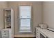 Well-lit office space with white desk, shelves, and a window with blind coverings at 3415 Crop Corner Rd, Suwanee, GA 30024