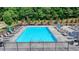 Inviting community pool surrounded by lounge chairs, umbrellas and manicured landscaping, perfect for relaxation and recreation at 3415 Crop Corner Rd, Suwanee, GA 30024