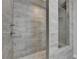 Contemporary shower featuring gray horizontal tiling and a pebble tiled floor at 3415 Crop Corner Rd, Suwanee, GA 30024