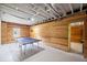 Finished basement with wooden walls, ceiling fan, and ping pong table at 1079 Angel Ln, Powder Springs, GA 30127