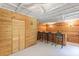 Finished basement with wooden walls and ceiling fan featuring a bar with seating at 1079 Angel Ln, Powder Springs, GA 30127