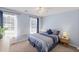 Bedroom features a comfortable queen-size bed, two windows, ceiling fan and light blue walls at 1079 Angel Ln, Powder Springs, GA 30127