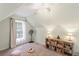 Attic bedroom featuring light-colored walls, carpet, natural light, and a ceiling fan at 1079 Angel Ln, Powder Springs, GA 30127