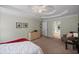 Large carpeted bedroom with neutral paint, ceiling fan, and ensuite bathroom access at 1079 Angel Ln, Powder Springs, GA 30127