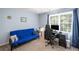 Bedroom with futon, desk and computer, light blue walls, and large window at 1079 Angel Ln, Powder Springs, GA 30127