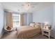 Bedroom features a comfortable bed, window, ceiling fan, and light blue walls at 1079 Angel Ln, Powder Springs, GA 30127