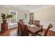 Bright dining room with hardwood floors, wainscoting, and large windows with a view of the yard at 1079 Angel Ln, Powder Springs, GA 30127
