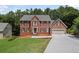 Charming two-story brick home with a well-manicured lawn and a spacious driveway at 1079 Angel Ln, Powder Springs, GA 30127