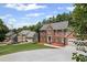 Traditional brick home in a serene neighborhood setting with well-maintained landscaping and ample parking at 1079 Angel Ln, Powder Springs, GA 30127