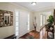 Warm and welcoming foyer with hardwood floors, a stylish mirror, and ample natural light at 1079 Angel Ln, Powder Springs, GA 30127