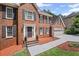 Inviting brick home featuring a classic entrance with a storm door, and a two-car garage at 1079 Angel Ln, Powder Springs, GA 30127