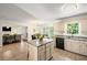 Bright kitchen with island, granite counters, and open to dining and living areas at 1079 Angel Ln, Powder Springs, GA 30127