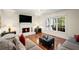 Cozy living room features a fireplace, mounted TV, and natural light at 1079 Angel Ln, Powder Springs, GA 30127