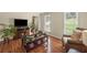 Cozy living room with a fireplace, hardwood floors, and comfortable seating area at 1079 Angel Ln, Powder Springs, GA 30127