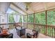 Relaxing screened porch with wood ceilings, ceiling fan, and cozy wicker furniture at 1079 Angel Ln, Powder Springs, GA 30127