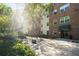 An outdoor courtyard is surrounded by mature landscaping and trees at 2965 Pharr Court South Nw # 1-110, Atlanta, GA 30305