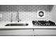 Modern kitchen features a stainless steel sink, gas stove, and white subway tile backsplash at 2965 Pharr Court South Nw # 1-110, Atlanta, GA 30305