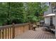 Back deck with patio seating and a view of the surrounding lush greenery at 8189 N Pine Cone N Dr, Villa Rica, GA 30180