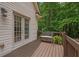 Back deck with seating and french doors, with a relaxing view of the surrounding greenery at 8189 N Pine Cone N Dr, Villa Rica, GA 30180