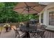 Outdoor deck with patio seating and an umbrella, perfect for entertaining and enjoying the serene nature views at 8189 N Pine Cone N Dr, Villa Rica, GA 30180