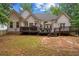 Backyard featuring a spacious wooden deck, white siding and a well-maintained lawn at 8189 N Pine Cone N Dr, Villa Rica, GA 30180