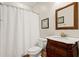 Bathroom with a decorative wood vanity, marble countertop, and shower with a white curtain at 8189 N Pine Cone N Dr, Villa Rica, GA 30180