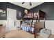 Charming bedroom with bunk beds, dark walls, wainscoting, and sports-themed accents at 8189 N Pine Cone N Dr, Villa Rica, GA 30180