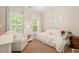 Cozy bedroom with white furniture, ample natural light, and a warm, inviting atmosphere at 8189 N Pine Cone N Dr, Villa Rica, GA 30180
