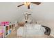 Large bonus room with sloped ceilings featuring a cozy couch and ample space at 8189 N Pine Cone N Dr, Villa Rica, GA 30180