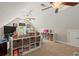 Spacious bonus room with built-in shelving and ceiling fans, perfect for a playroom at 8189 N Pine Cone N Dr, Villa Rica, GA 30180