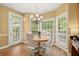 Bright breakfast nook with hardwood floors and natural light from the surrounding windows at 8189 N Pine Cone N Dr, Villa Rica, GA 30180