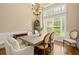 Elegant dining room features a chandelier, wainscoting, and natural light from the large window at 8189 N Pine Cone N Dr, Villa Rica, GA 30180