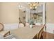 Bright dining room featuring a chandelier, wainscoting, and access to the living room at 8189 N Pine Cone N Dr, Villa Rica, GA 30180