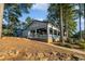 Charming lakeside restaurant with outdoor seating and scenic views surrounded by mature trees at 8189 N Pine Cone N Dr, Villa Rica, GA 30180