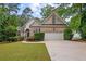 Attractive brick home with a well-kept lawn, surrounded by mature trees for added privacy at 8189 N Pine Cone N Dr, Villa Rica, GA 30180