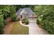 Charming brick home with a well-manicured lawn, lush landscaping, and a paved driveway at 8189 N Pine Cone N Dr, Villa Rica, GA 30180