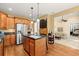 Spacious kitchen featuring stainless appliances, an island, and access to the living room at 8189 N Pine Cone N Dr, Villa Rica, GA 30180