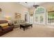 Bright living room featuring a ceiling fan, neutral walls and carpet, and a large window at 8189 N Pine Cone N Dr, Villa Rica, GA 30180