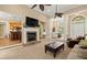 Open-concept living room with a fireplace, columns, and easy access to the kitchen and dining areas at 8189 N Pine Cone N Dr, Villa Rica, GA 30180