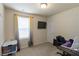 Carpeted room with a window, TV on the wall, desk, and a chair at 5622 Laurel Ridge Dr, Atlanta, GA 30344