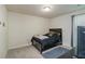 Carpeted bedroom with a dark wood bed frame, dresser, and a TV on the wall at 5622 Laurel Ridge Dr, Atlanta, GA 30344