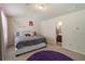 This bedroom features a large comfortable bed, accent wall art, and an ensuite bathroom at 5622 Laurel Ridge Dr, Atlanta, GA 30344